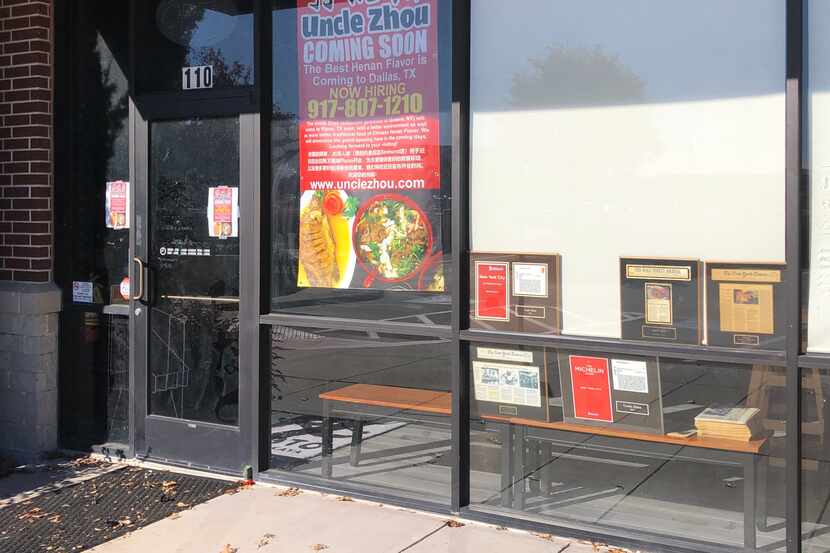 Uncle Zhou's coming-soon signs are displayed in the window of the restaurant in Plano. Owner...