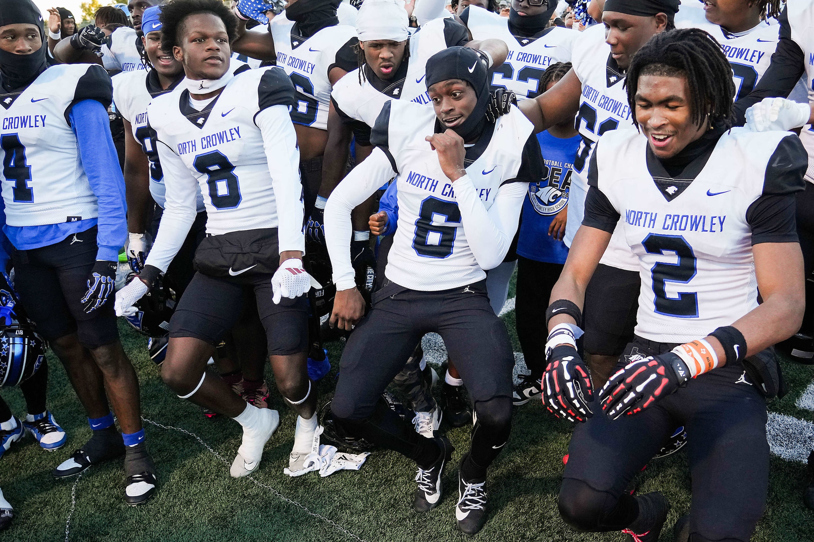 North Crowley wide receiver Quentin Gibson (6) dances with teammates Aaron Bradshaw (8) and...