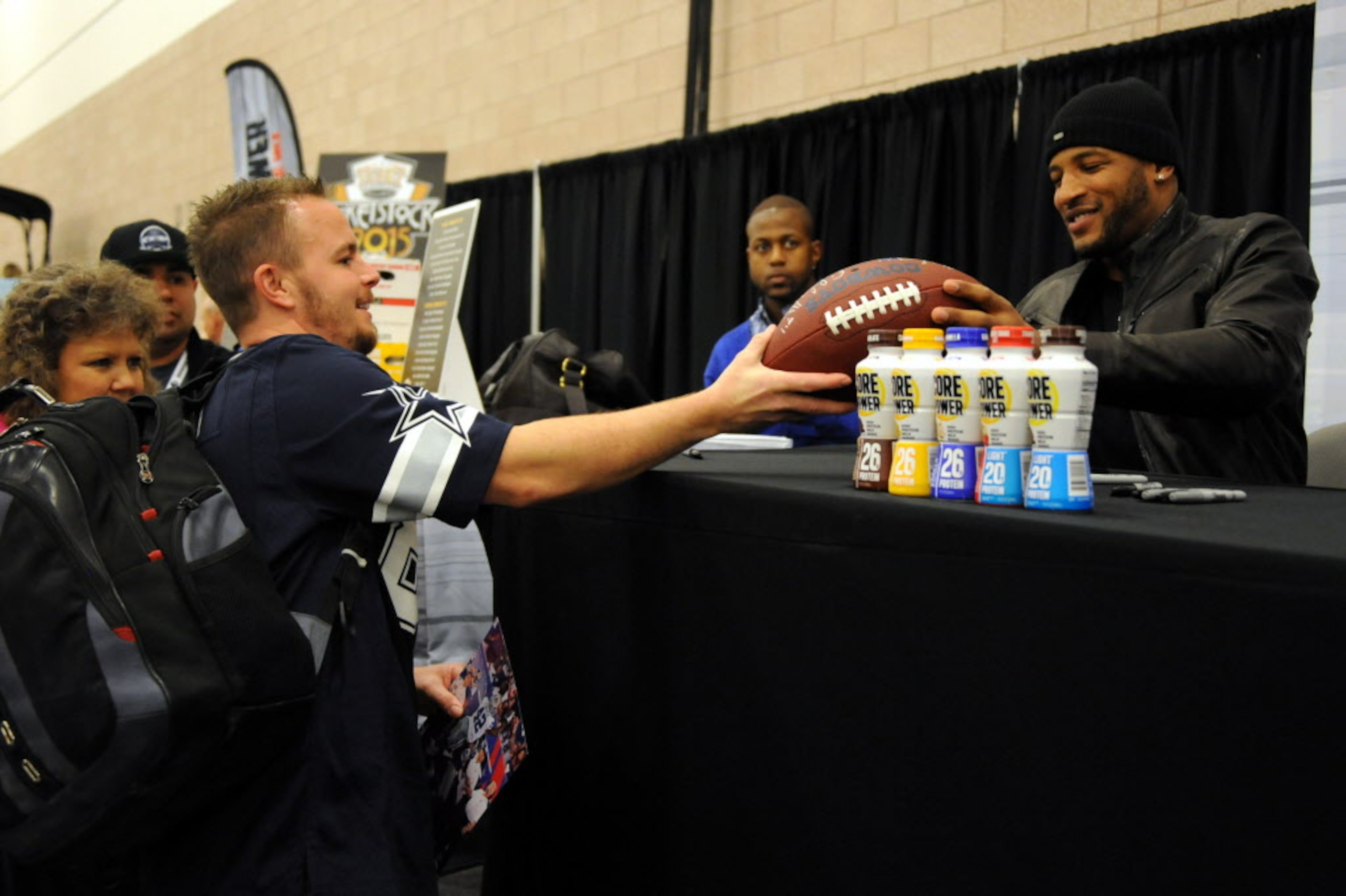 Dallas Cowboys strong safety Barry Church signs a football for a fan at The Ticket...