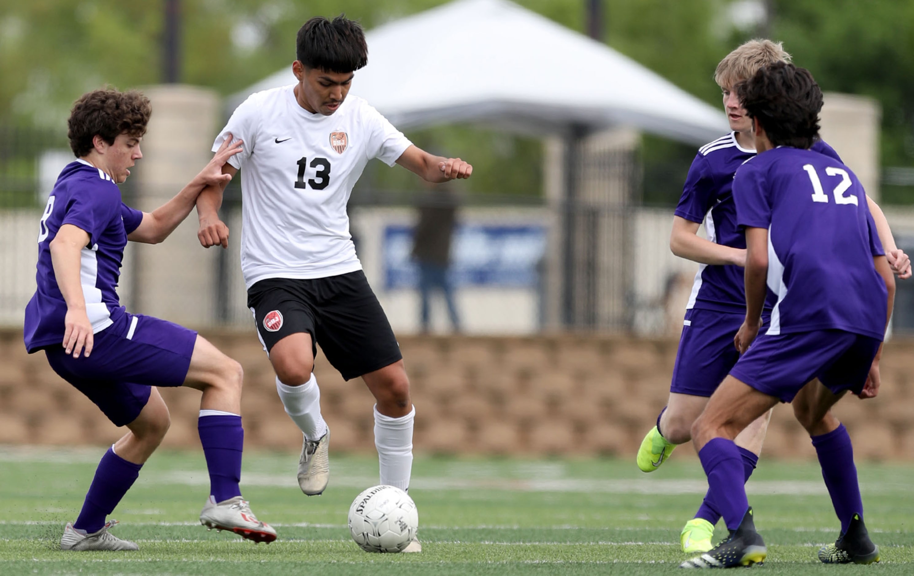 Fort Worth Diamond Hill-Jarvis' Edward Zuniga (13) looks for room around Boerne's Brett...