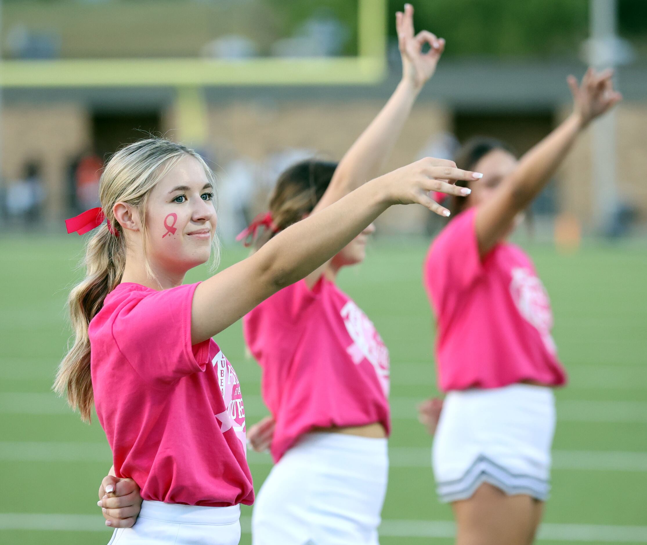 Wylie East cheerleaders celebrate Breast Cancer Award Month dressed in pink with pink...