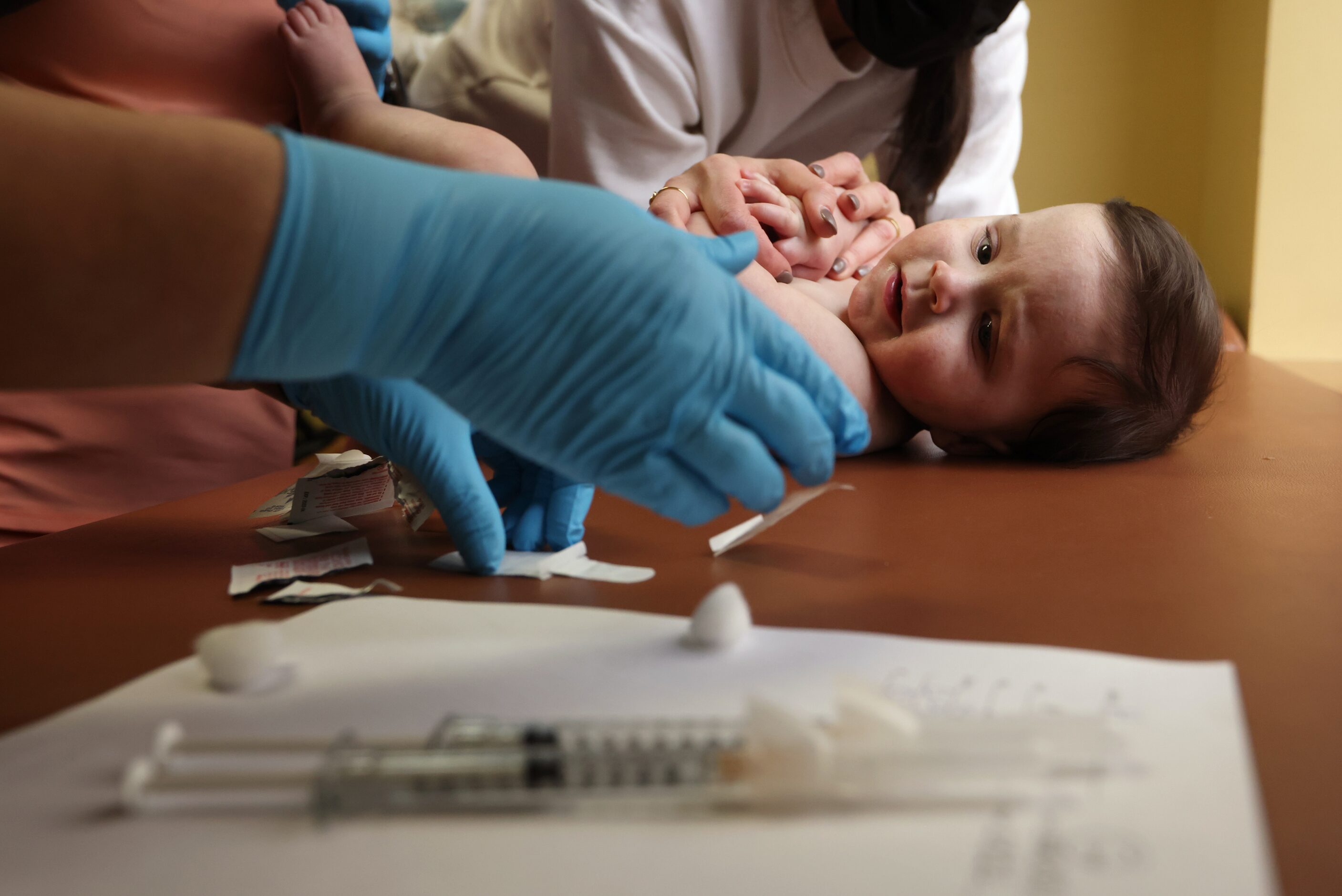 Henry Marr looks over before getting a shot during a medical appointment on Tuesday, January...