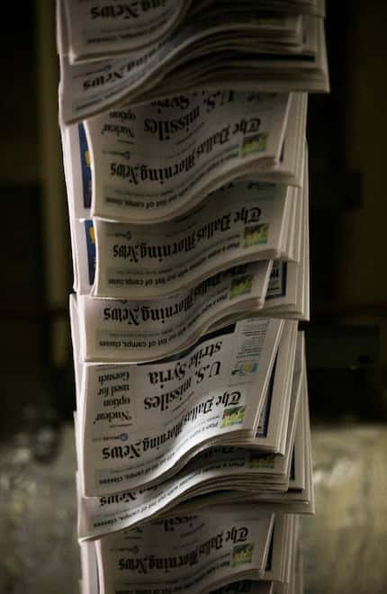 Copies of The Dallas Morning News move through the company's printing plant in Plano.