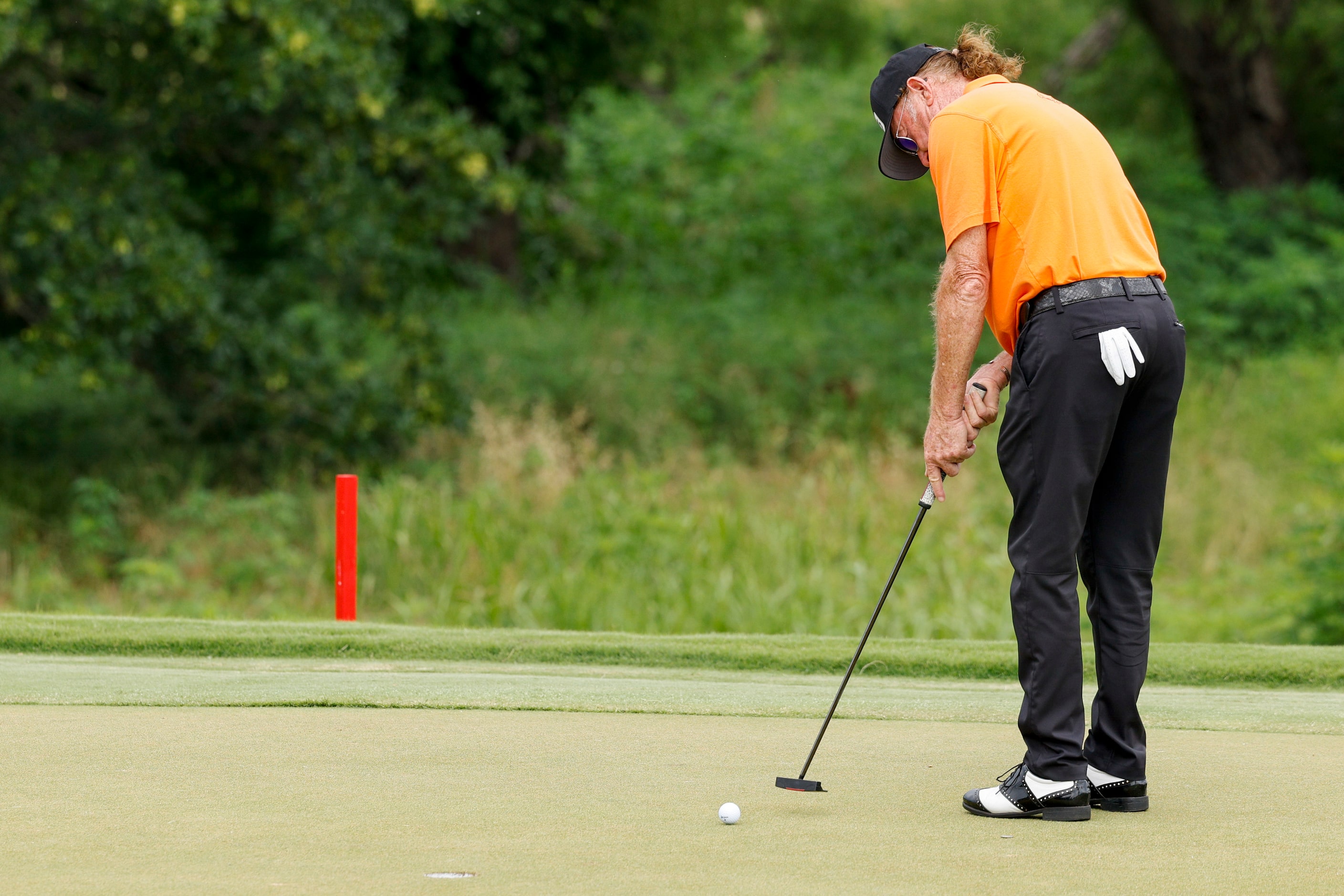 Miguel Angel Jiménez of Spain putts for birdie on the 18th hole during the first round of...