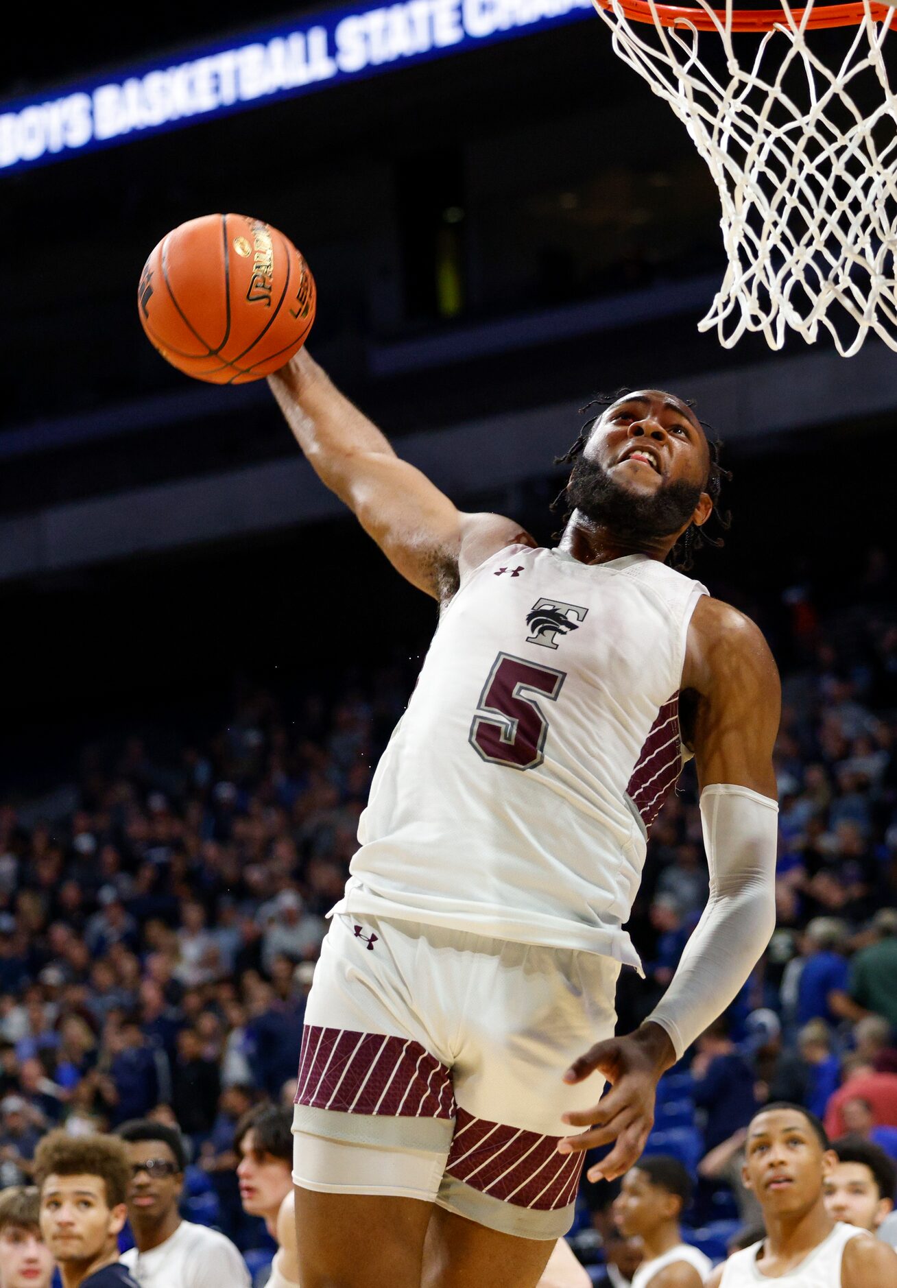 Mansfield Timberview guard Jared Washington (5) celebrates with a dunk after defeating...