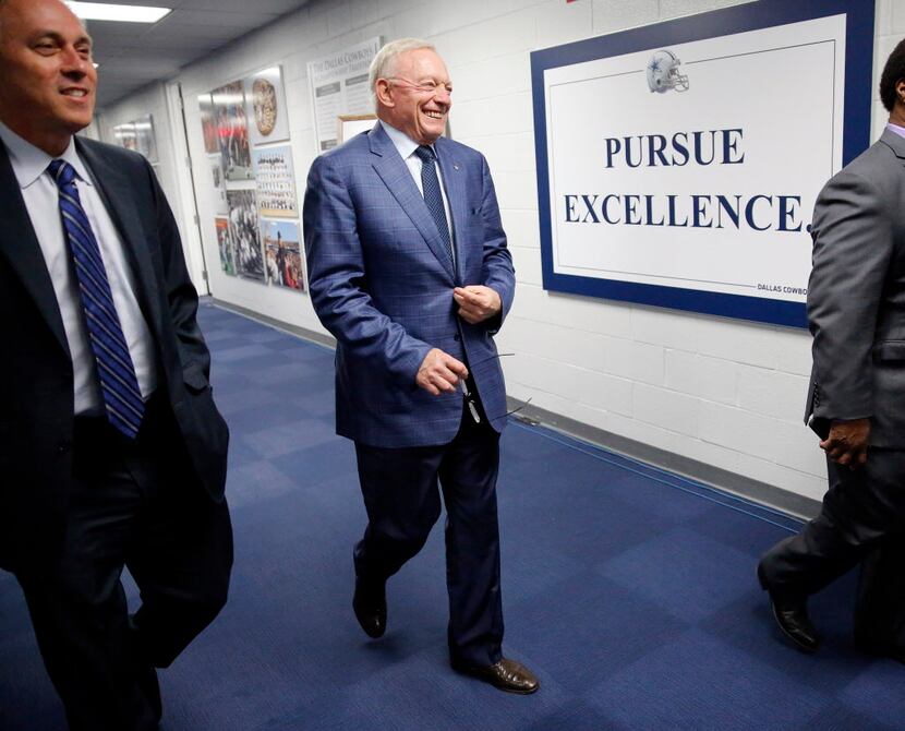Dallas Cowboys owner Jerry Jones (center) arrives to a news conference about their first...