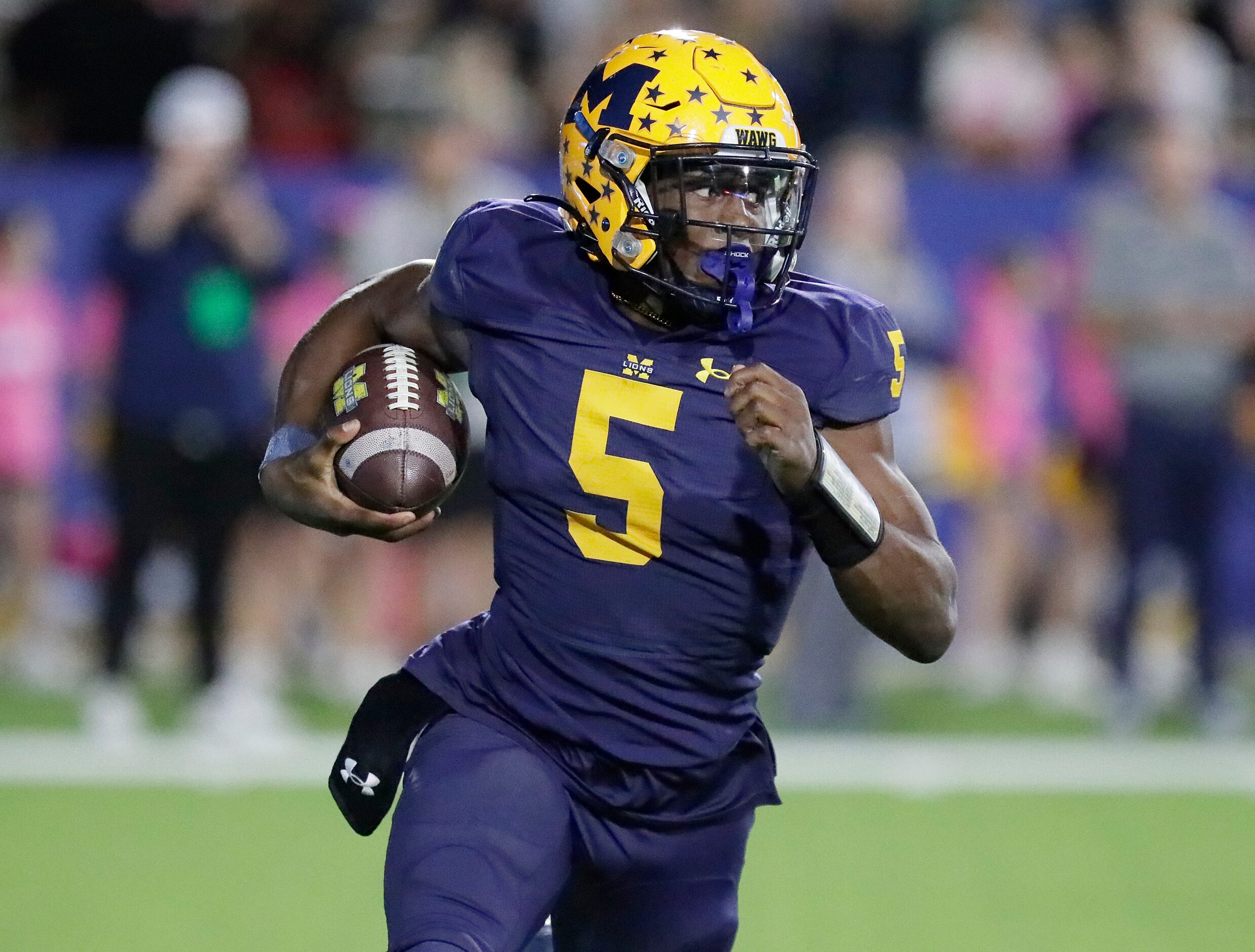 McKinney High School quarterback Godspower Nwawuihe (5) carries the football during the...