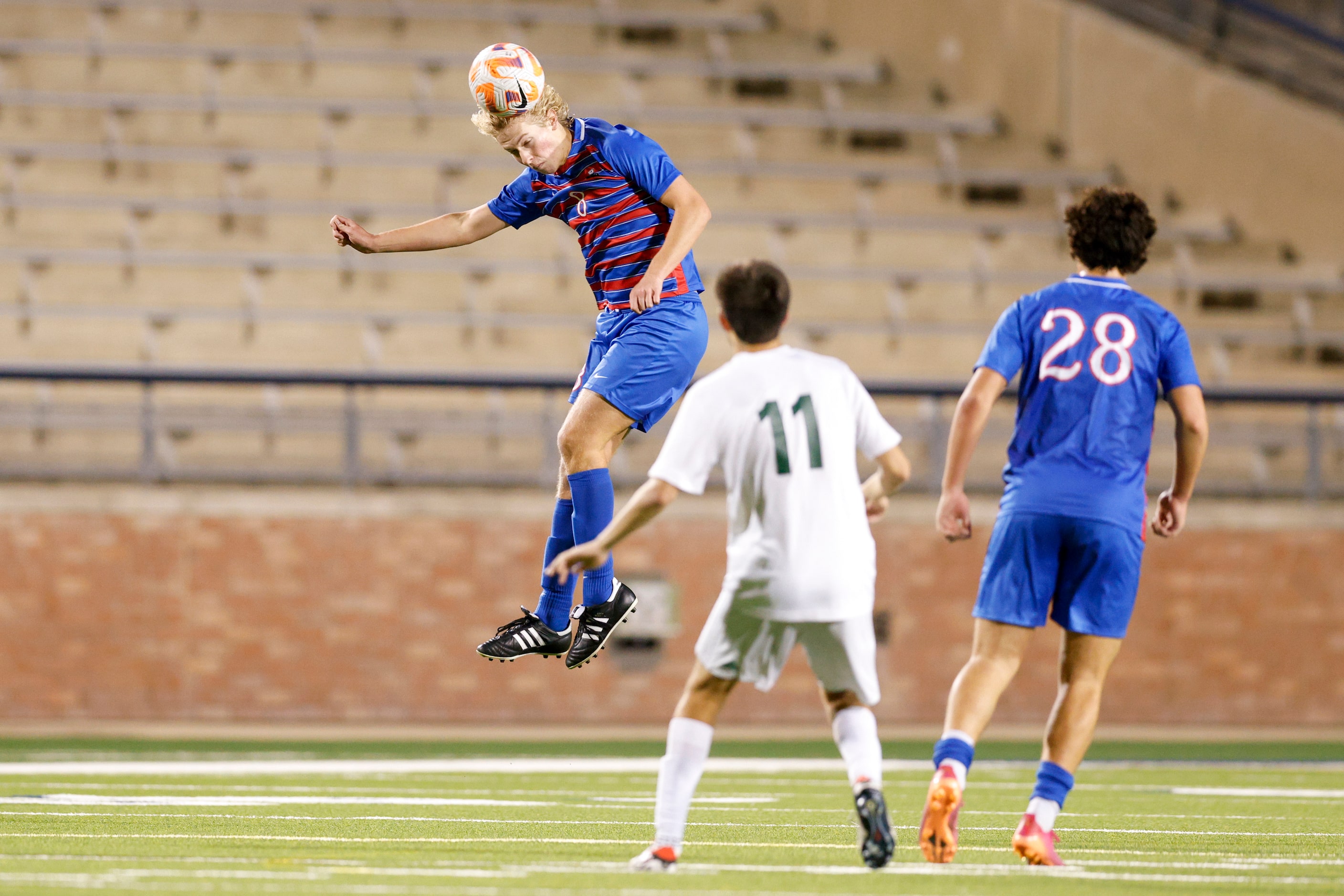 Allen’s Cade Dollarhide (8) heads the ball near Evan Ruiz (28) and Prosper’s Gavin Lyons...