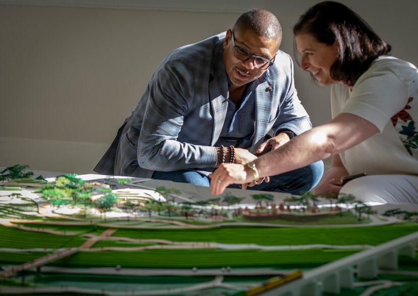 Darren James, a Trinity Park Conservatory board member, left, listens while Elizabeth...