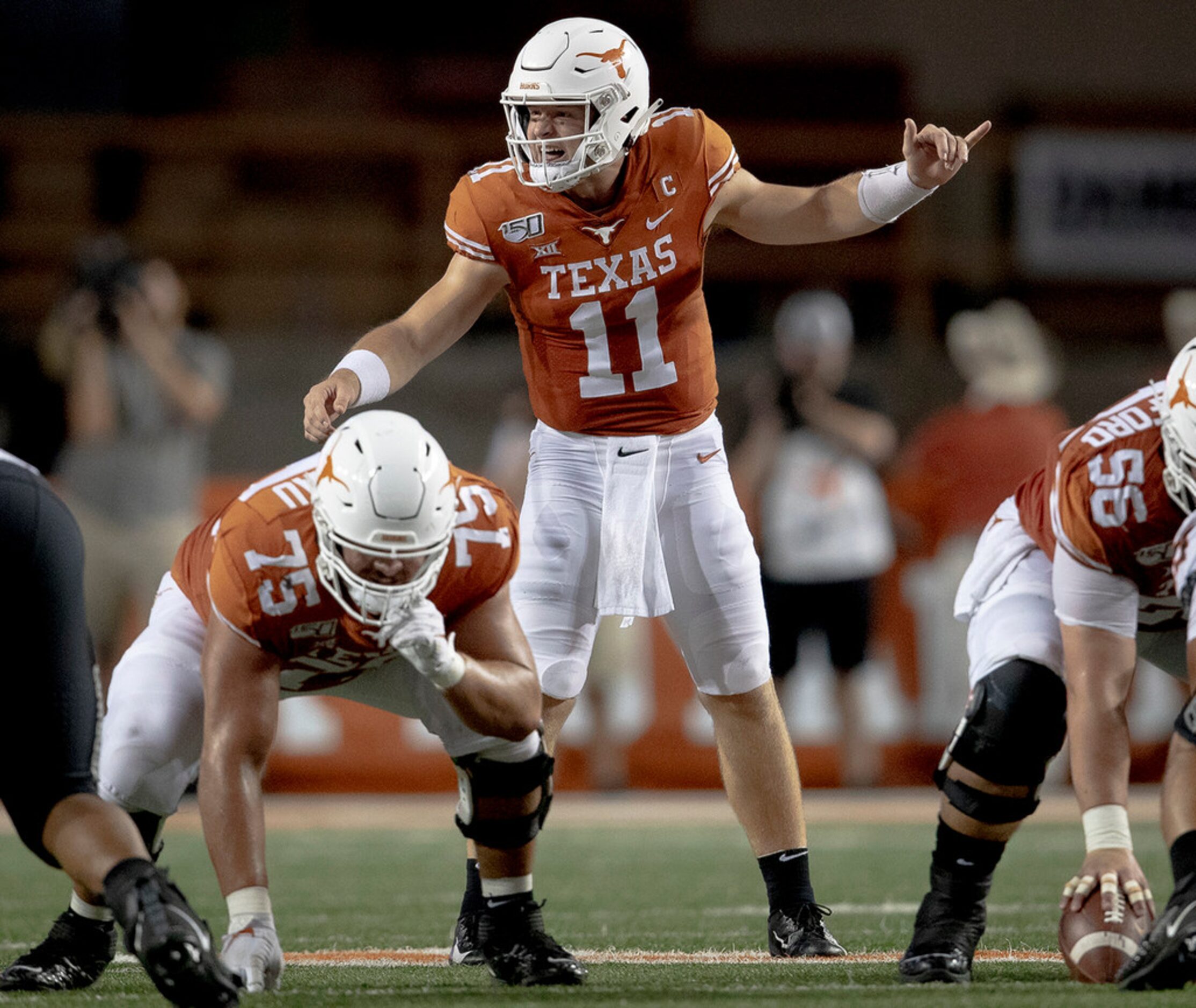 Texas quarterback Sam Ehlinger (11) shouts to his lineman against Oklahoma State on...