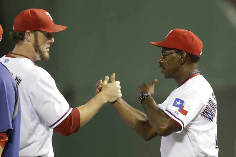 Texas Rangers closer Joe Nathan, left, gets a congrats from manager Ron Washington after the...