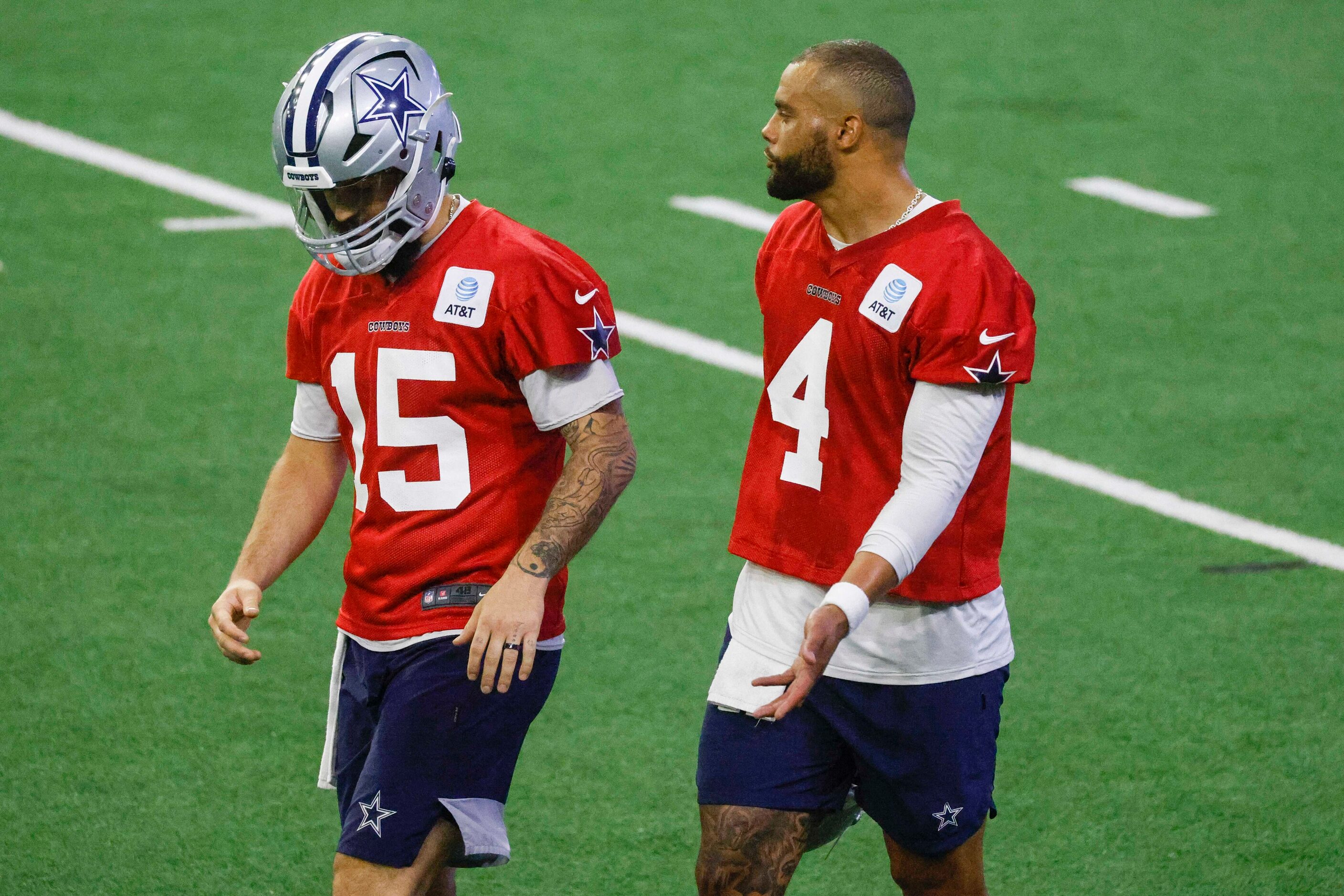 Dallas Cowboys quarterback Will Grier (left) talks to quarterback Dak Prescott during OTA...