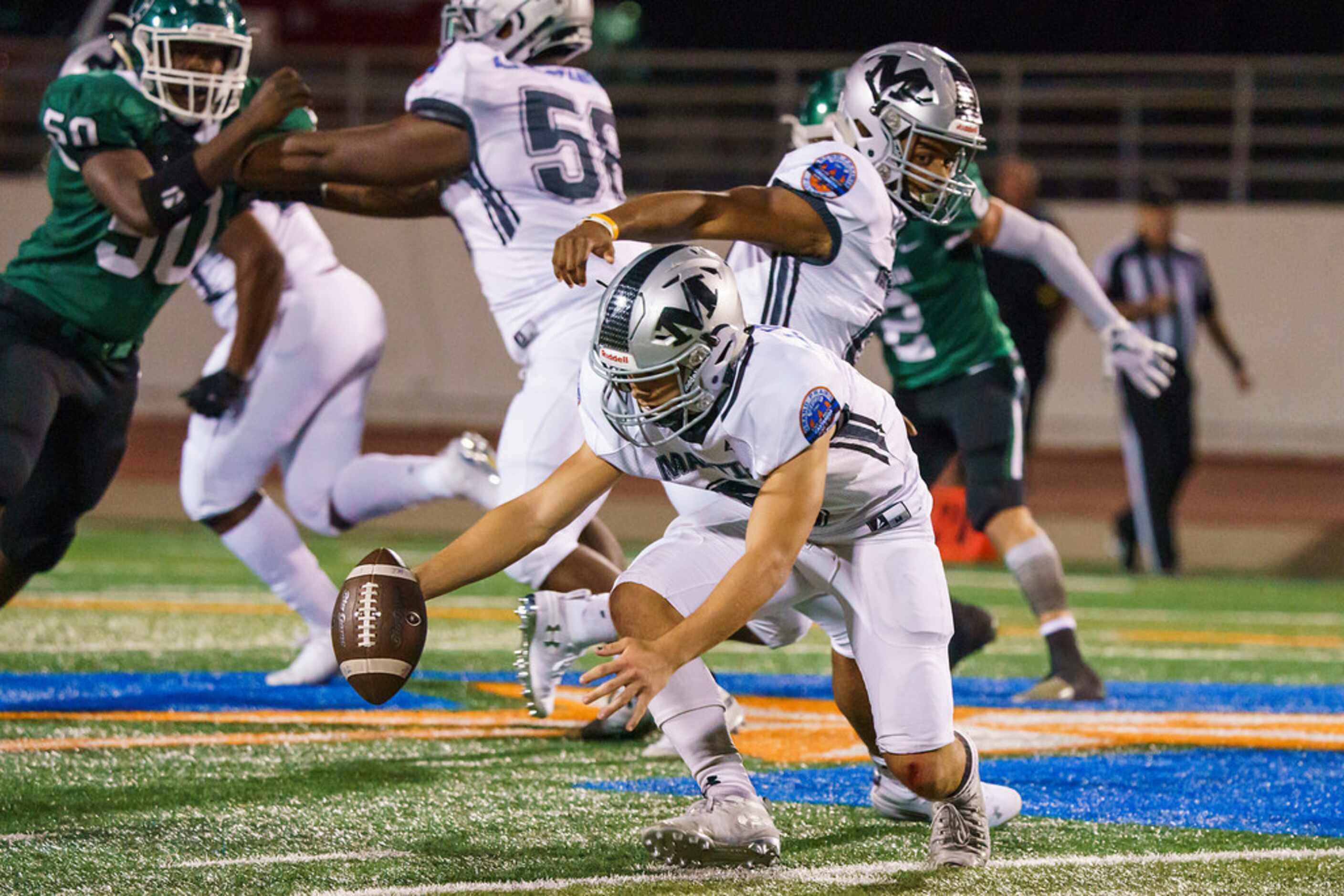 Arlington Martin quarterback Zach Mundell (6) chases his own fumble during the first half of...