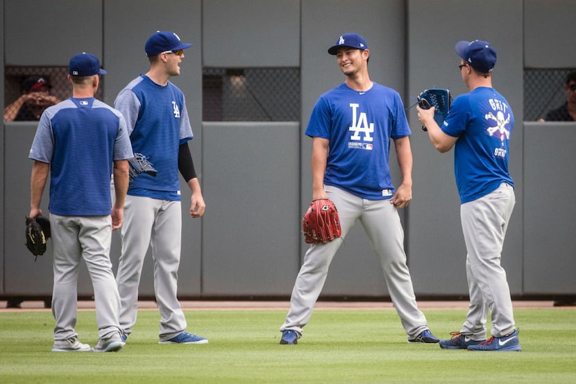 Los Angeles Dodgers' Yu Darvish, second from right, Austin Barnes, left, Alex Wood, and Joc...