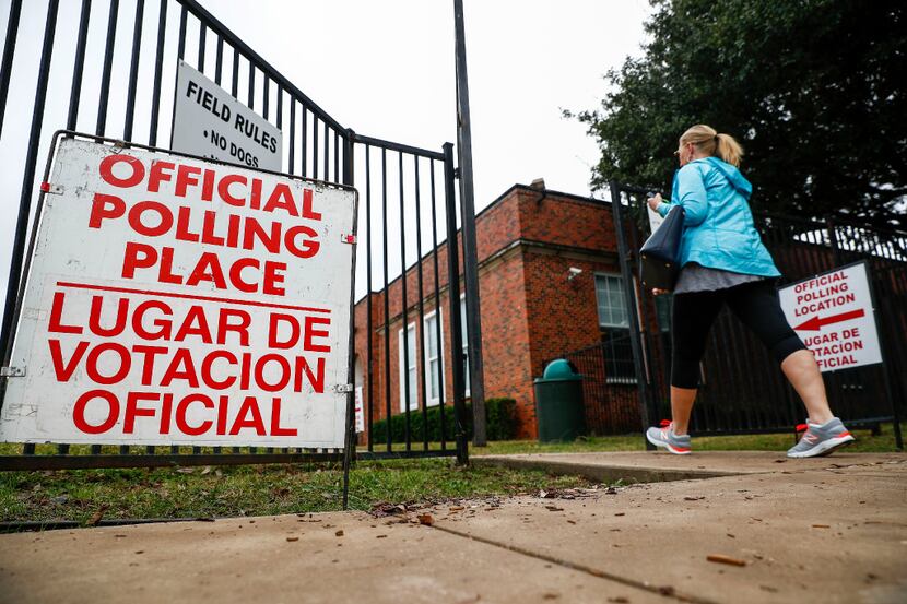 People arrive at a polling station at Robert S. Hyer Elementary to cast their ballot for the...