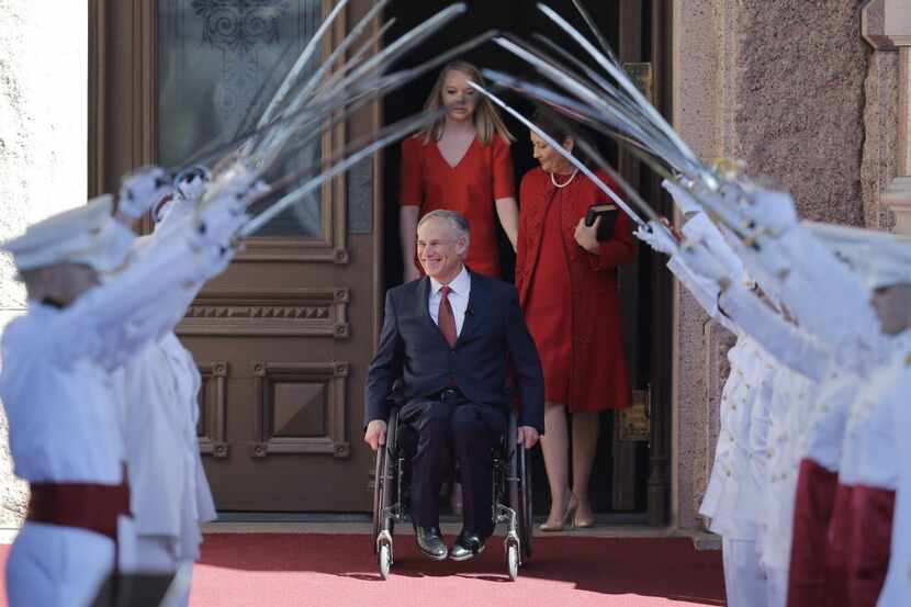  Greg Abbott, center, arrives for his inauguration as Texas governor on Jan. 20 in Austin....