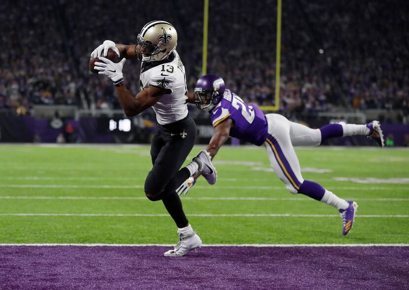 New Orleans Saints wide receiver Michael Thomas (13) makes a catch for a touchdown behind...
