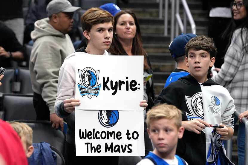 A young fans holds up a sign for Dallas Mavericks guard Kyrie Irving prior to an NBA...