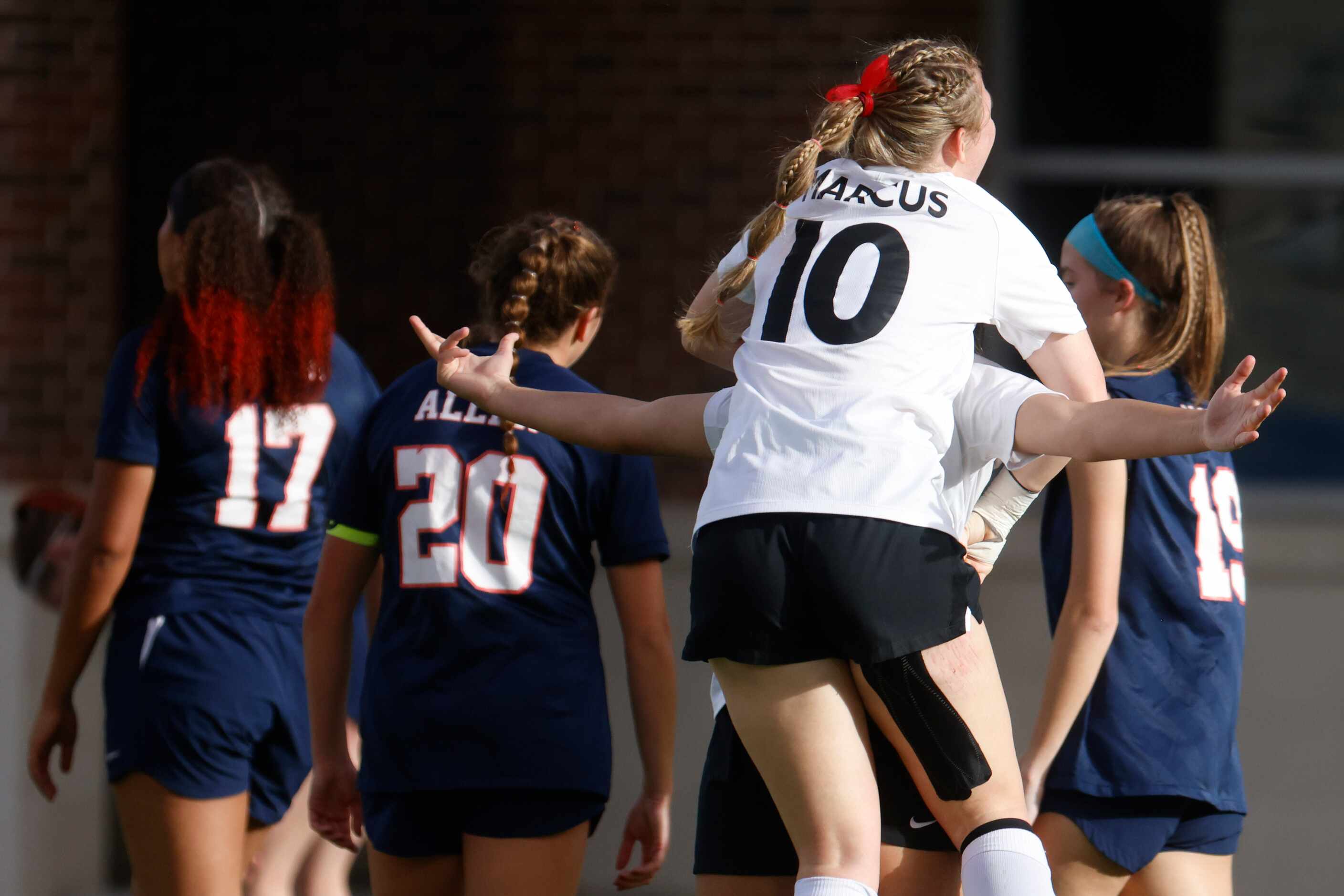 Marcus’ Allie Williams (10) and Bella Campos celebrates after their first goal against Allen...