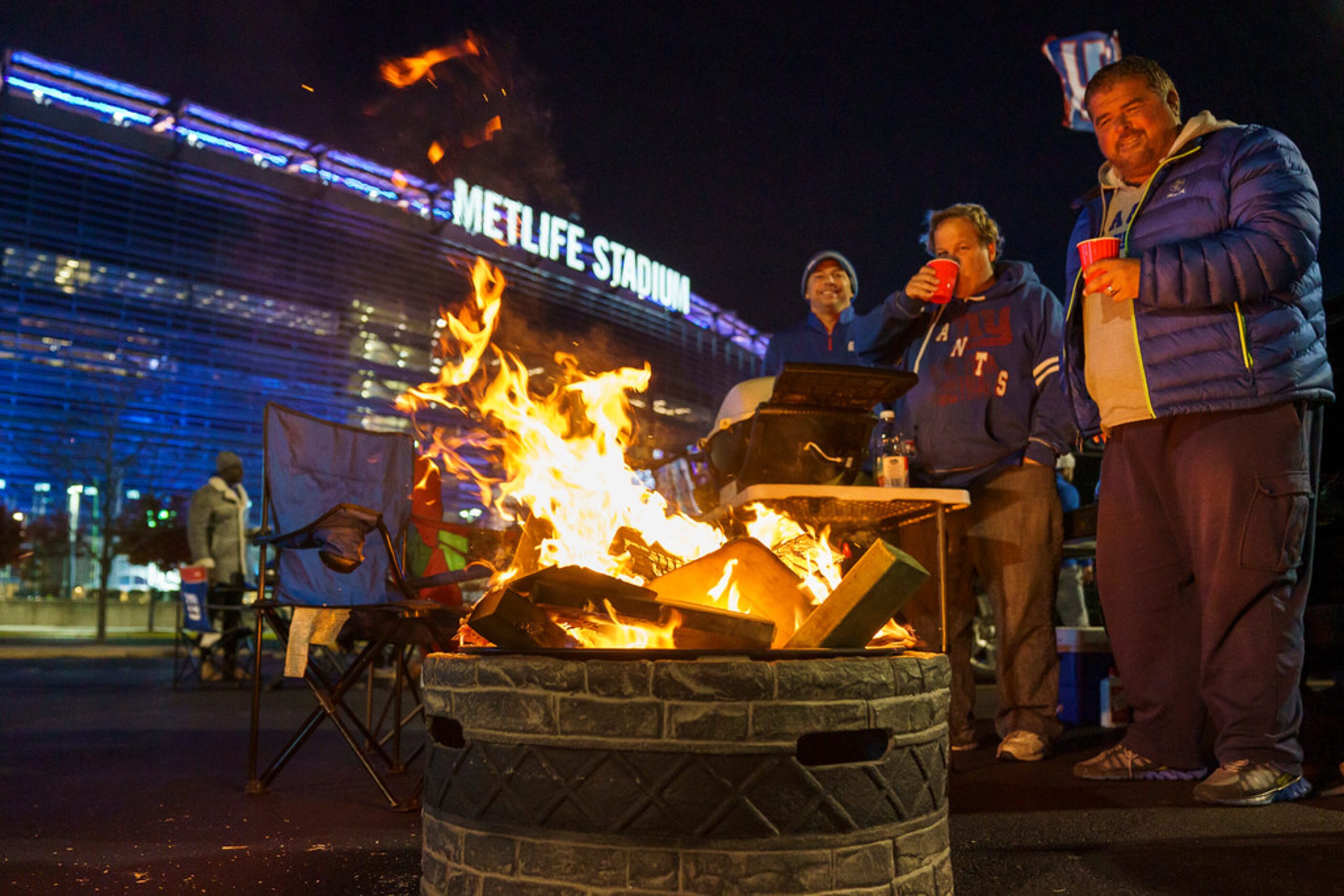 New York Giants fans tailgate before a Monday Night Football game between the Dallas Cowboys...