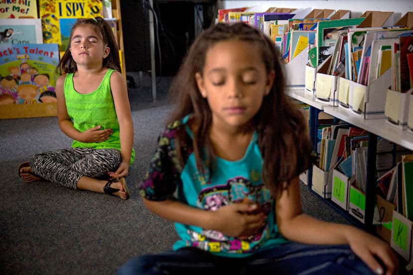 Felicity Veliz (left) and Kalyssa Flynn work on breathing techniques during a mindfulness...