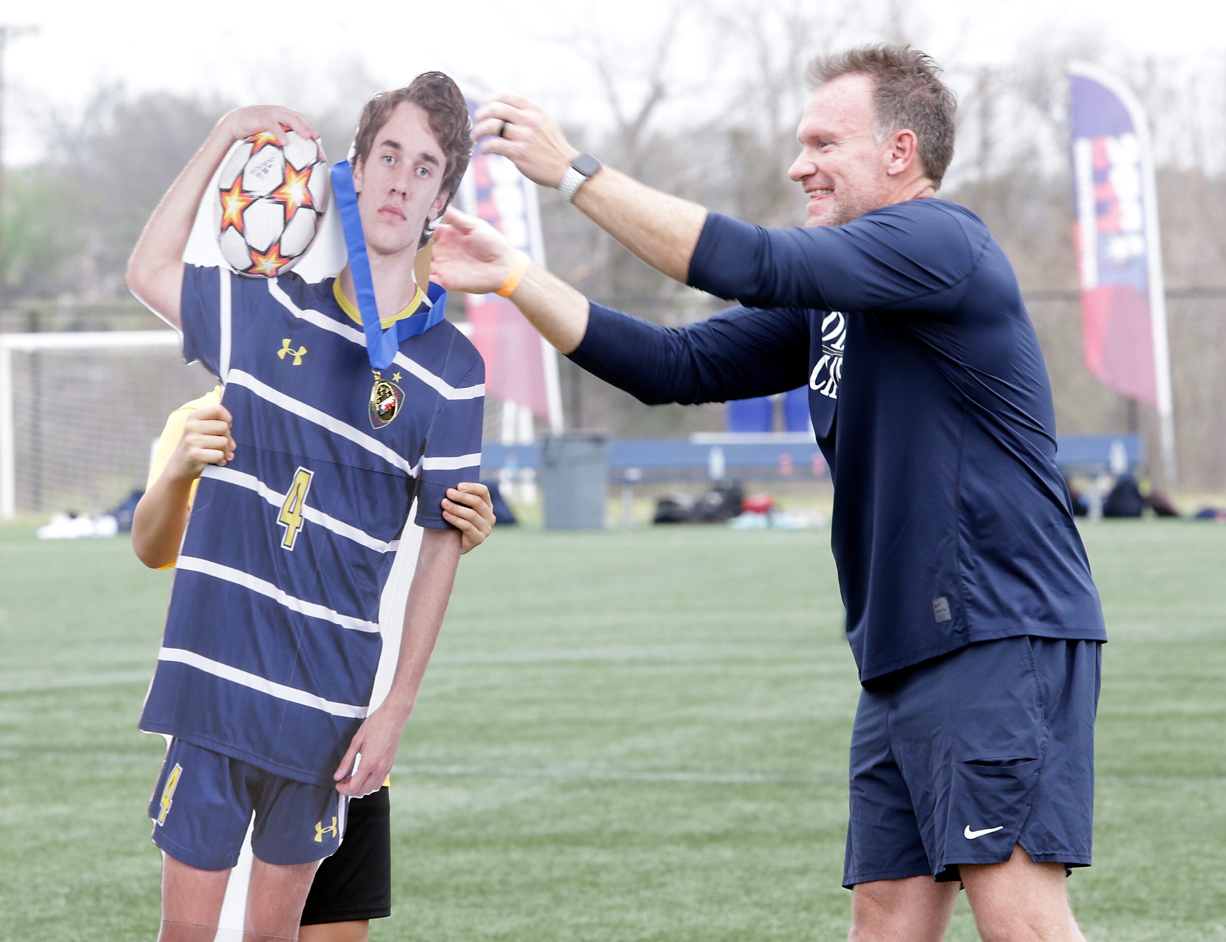 Coach Todd OÕNeal present a medal to the cutout of player #4 Benjamin Anderson who was on a...