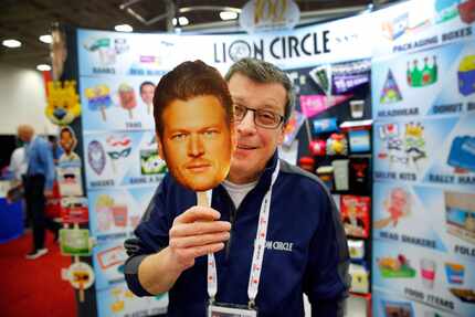 Lion Circle vice president of sales Tom Swientek shows off his hand fans they are marketing...