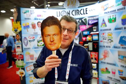 Lion Circle vice president of sales Tom Swientek shows off his hand fans they are marketing...