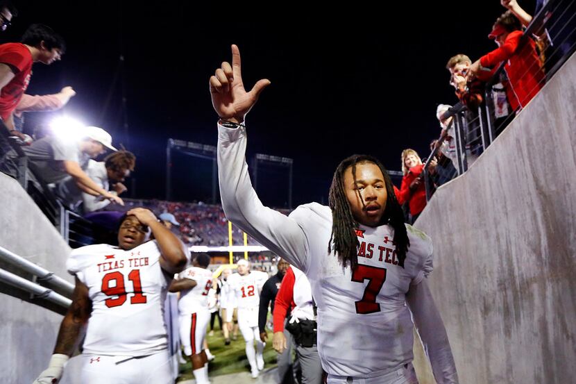 Texas Tech Red Raiders quarterback Jett Duffey (7) waves to fans as he walks off the field...