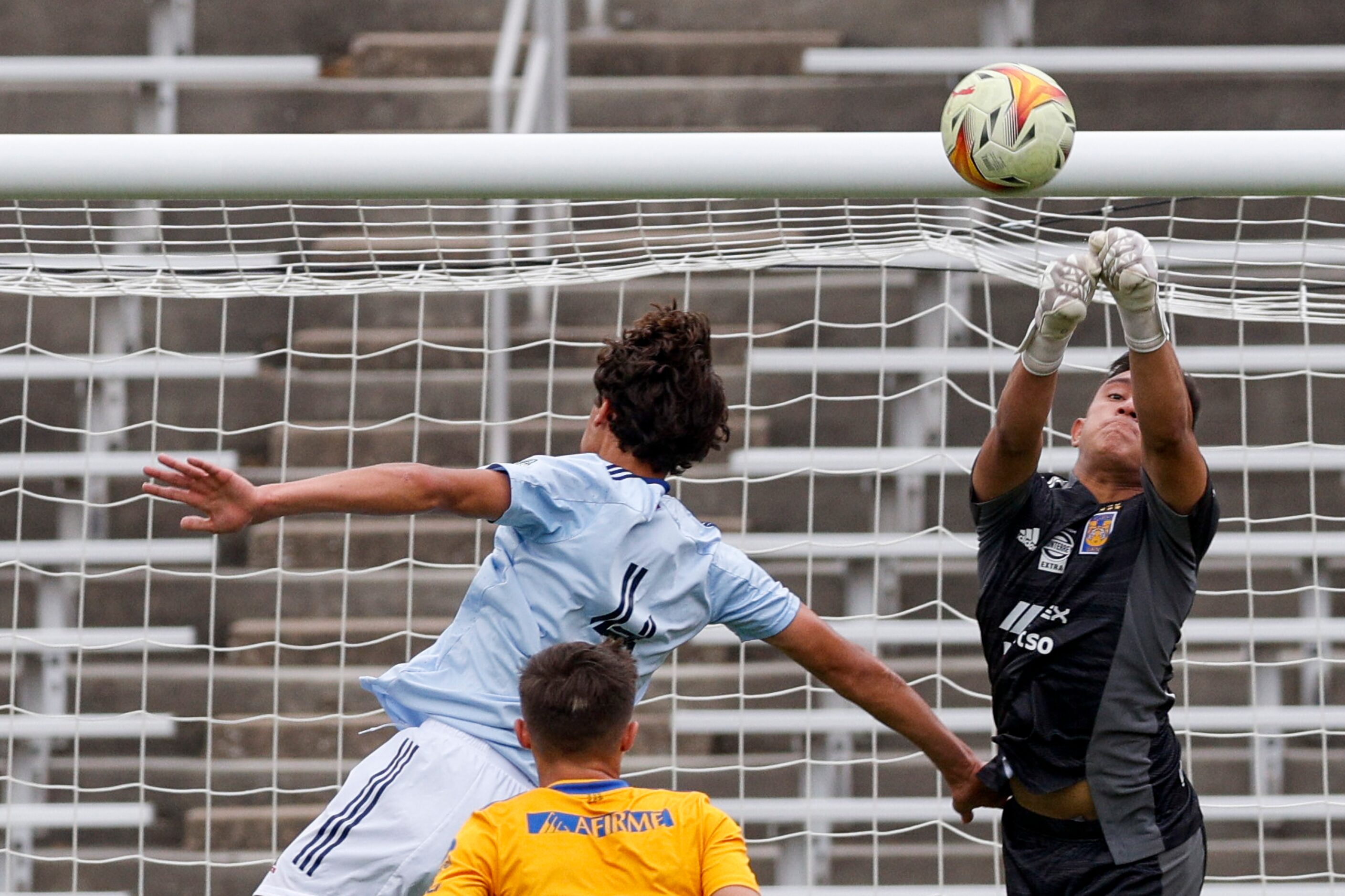 Tigres UANL goalie Santiago Garcia Altamirano punches the ball clear over FC Dallas’ Will...