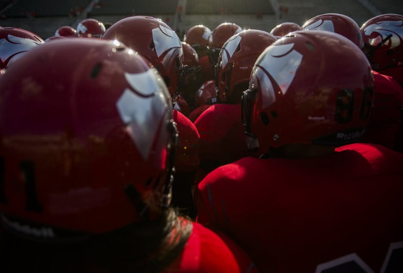 Mesquite Horn football players huddle during warmups before their game against McKinney Boyd...