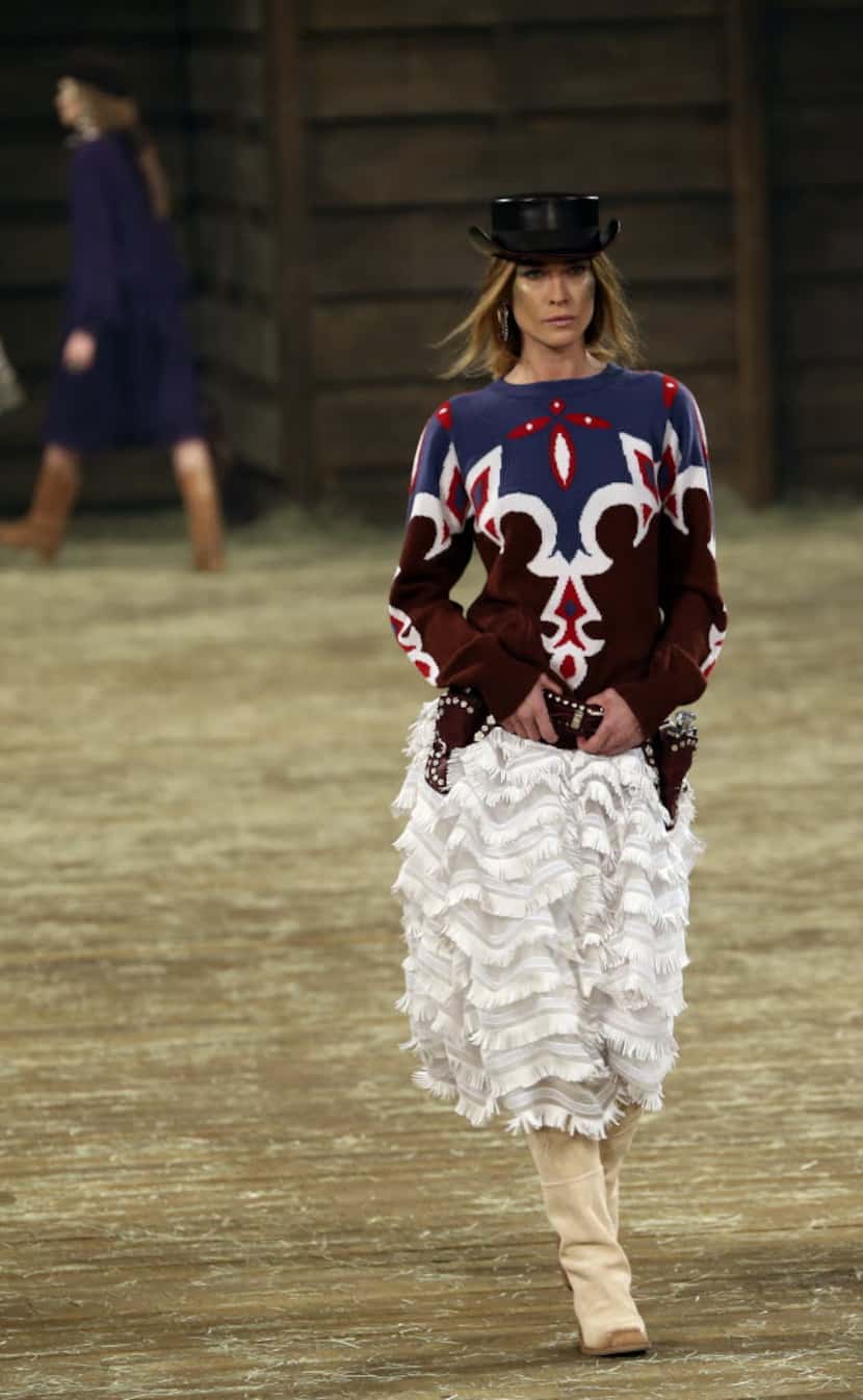 Model Erin Wasson walks the runway at the Chanel Metiers d'Art pre-fall 2014 fashion show...