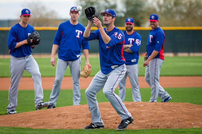 Texas Rangers starting pitcher Cole Hamels participates in a fielding drill during a spring...