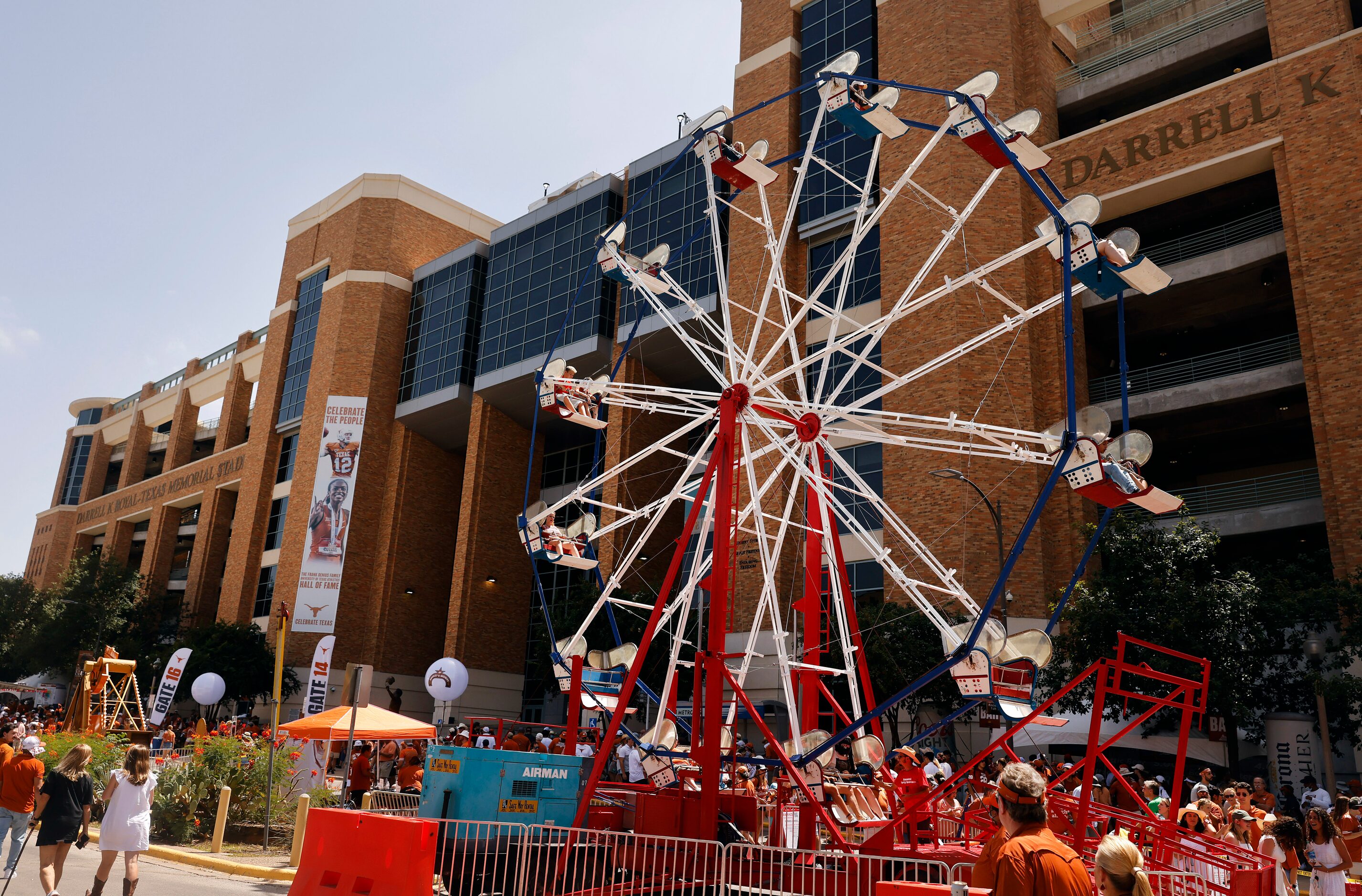 Fans ride the ferris wheel erected along Smokey's Midway outside of DKR-Texas Memorial...