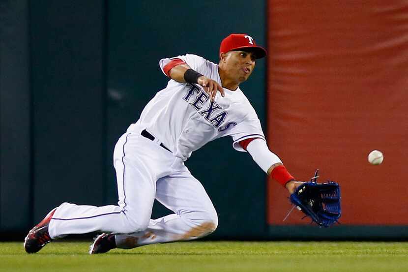 ARLINGTON, TX - APRIL 11:  Leonys Martin #2 of the Texas Rangers dives to make the catch for...