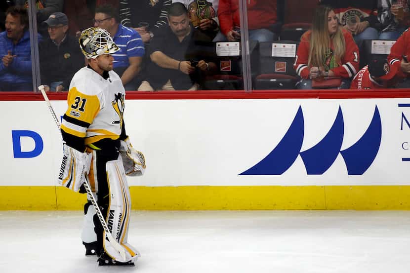 Pittsburgh Penguins goalie Antti Niemi skates to the bench during the first period of an NHL...