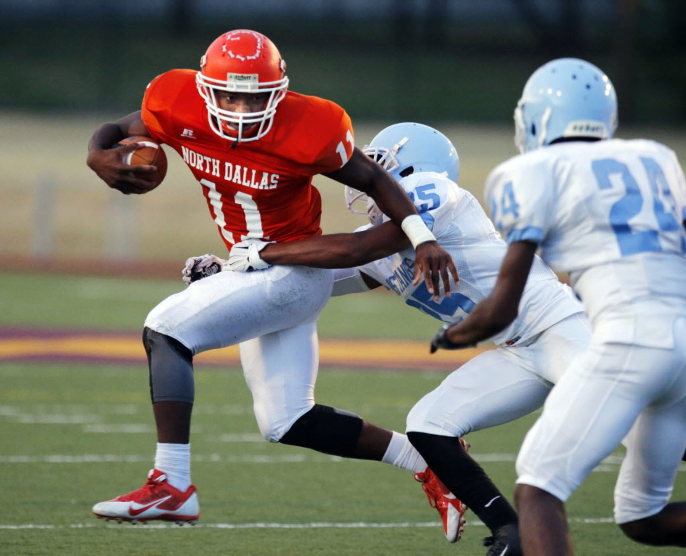 (TXHSFB) North Dallas RB Geovoni Manning (11) tries to advance the ball, but is hit by...