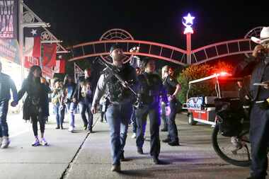Dallas police officers work near the scene of a shooting at the State Fair of Texas on...