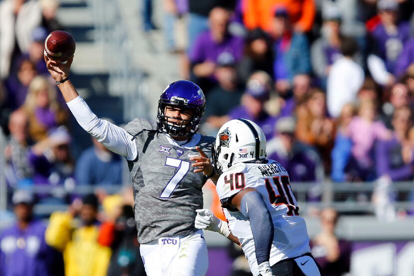TCU Horned Frogs quarterback Kenny Hill (7) release a pass downfield as he is chased by...