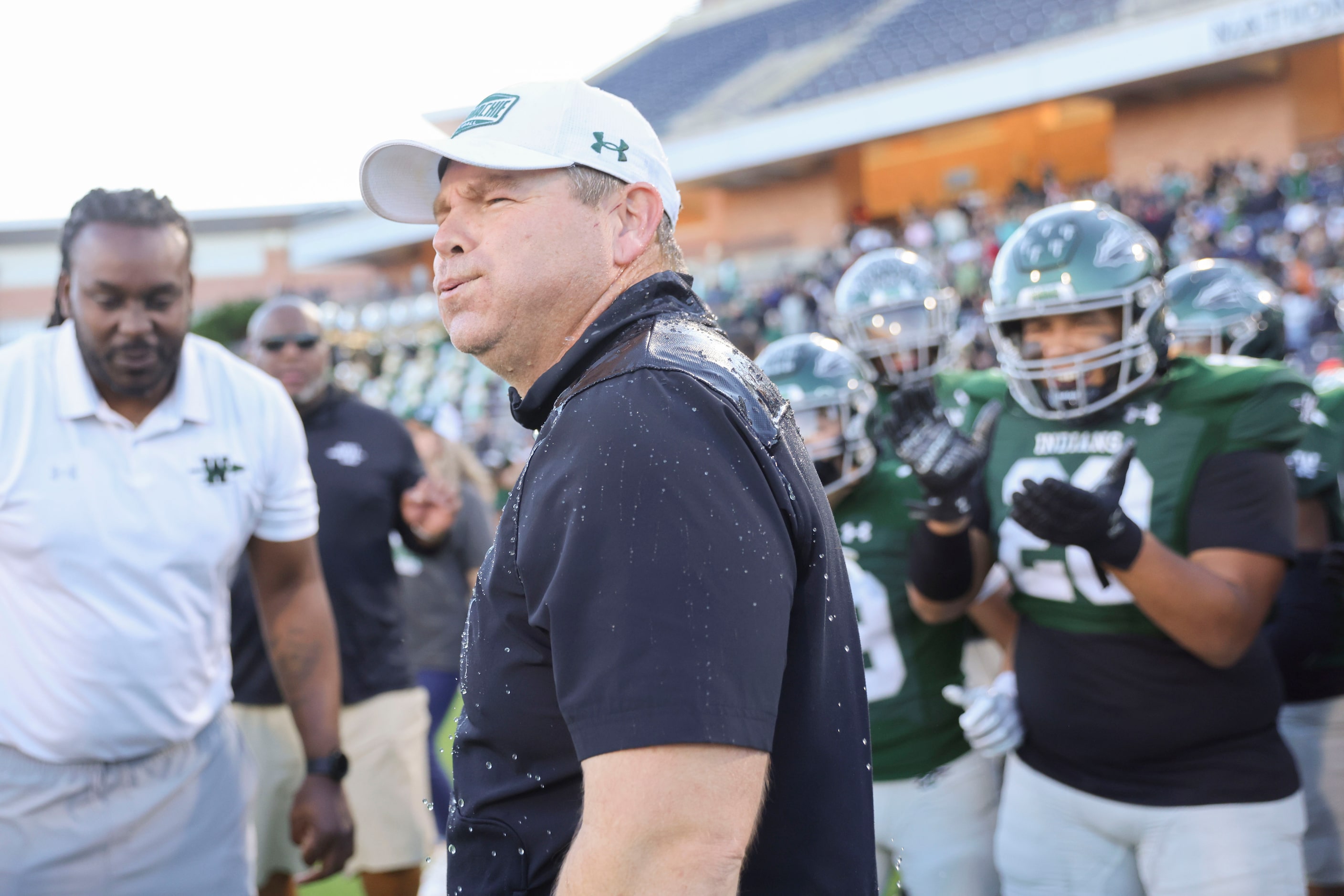 Waxahachie High football head coach Shane Tolleson reacts after a gatorade dunk following...