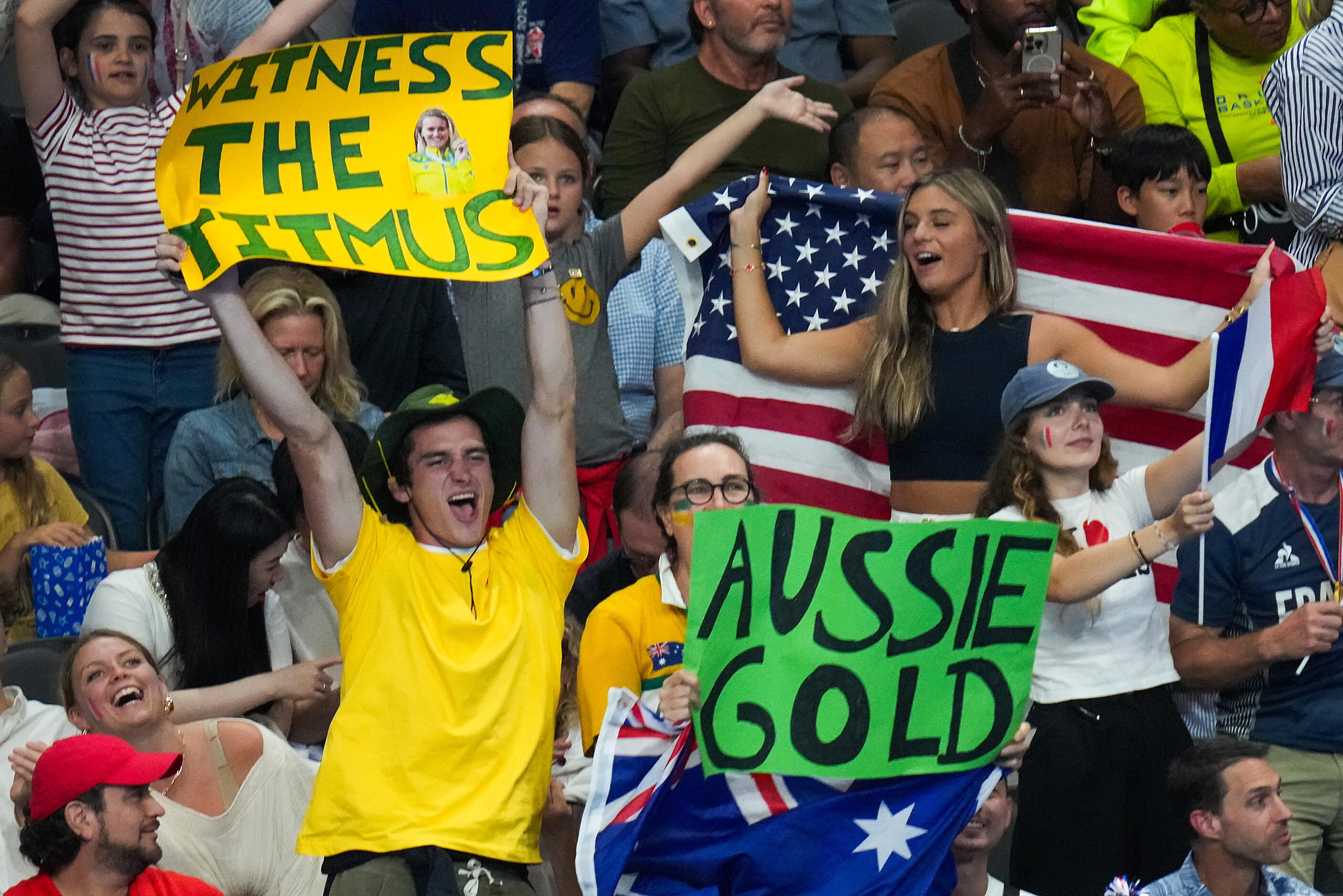 Fans cheer after the  4x100-meter freestyle relay at the 2024 Summer Olympics on Saturday,...