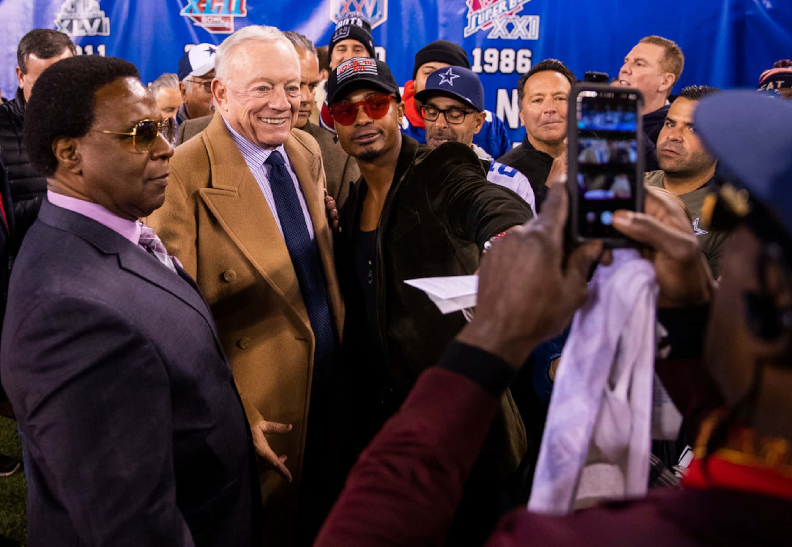 Dallas Cowboys Owner Jerry Jones takes photos with fans before an NFL game between the...