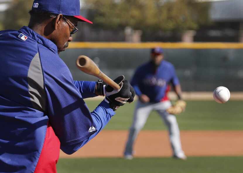 Texas manager Ron Washington hits grounders to shortstop Elvis Andrus during Texas Rangers...