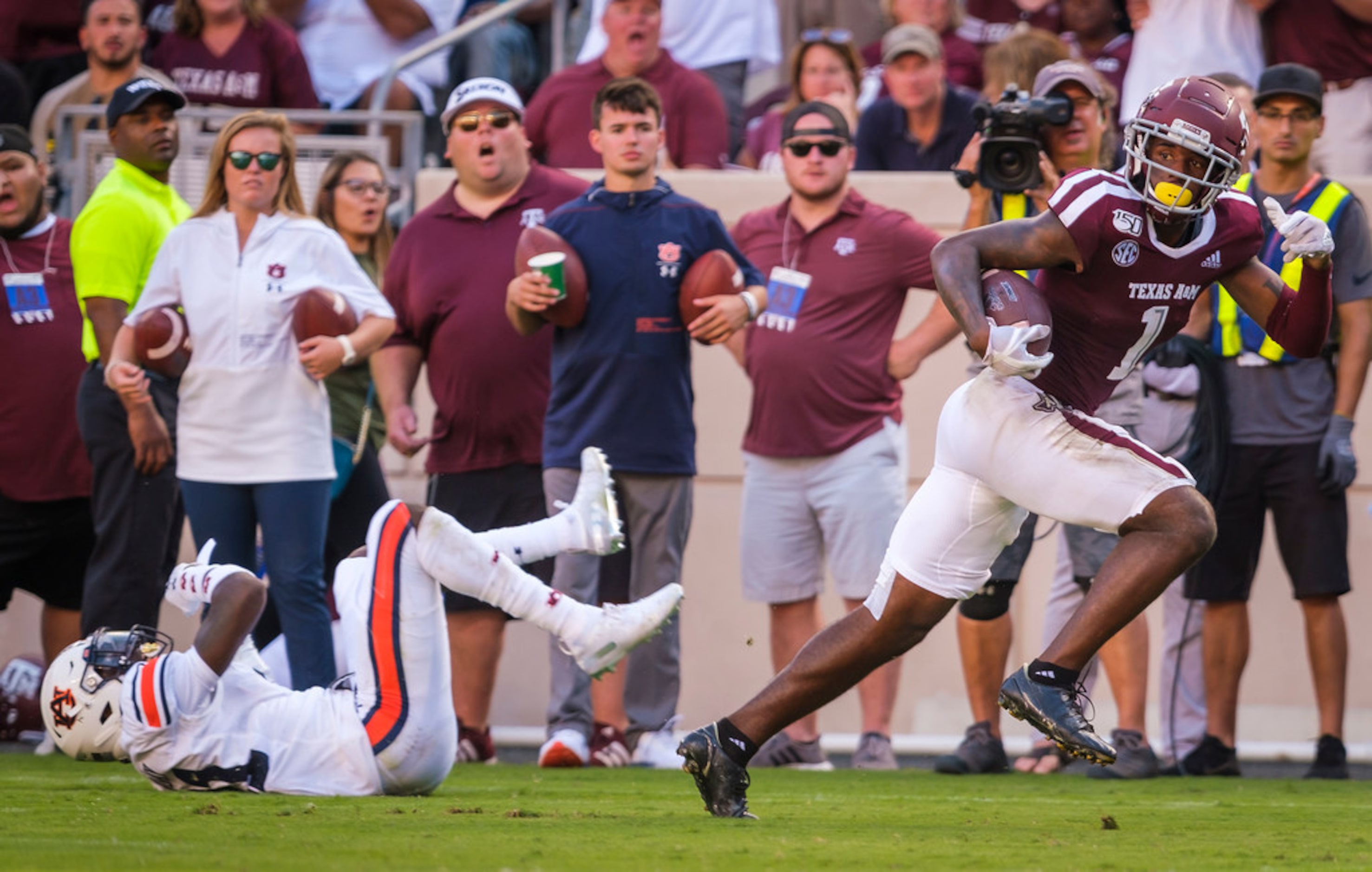 Texas A&M wide receiver Quartney Davis (1) gets past Auburn defensive back Smoke Monday (21)...