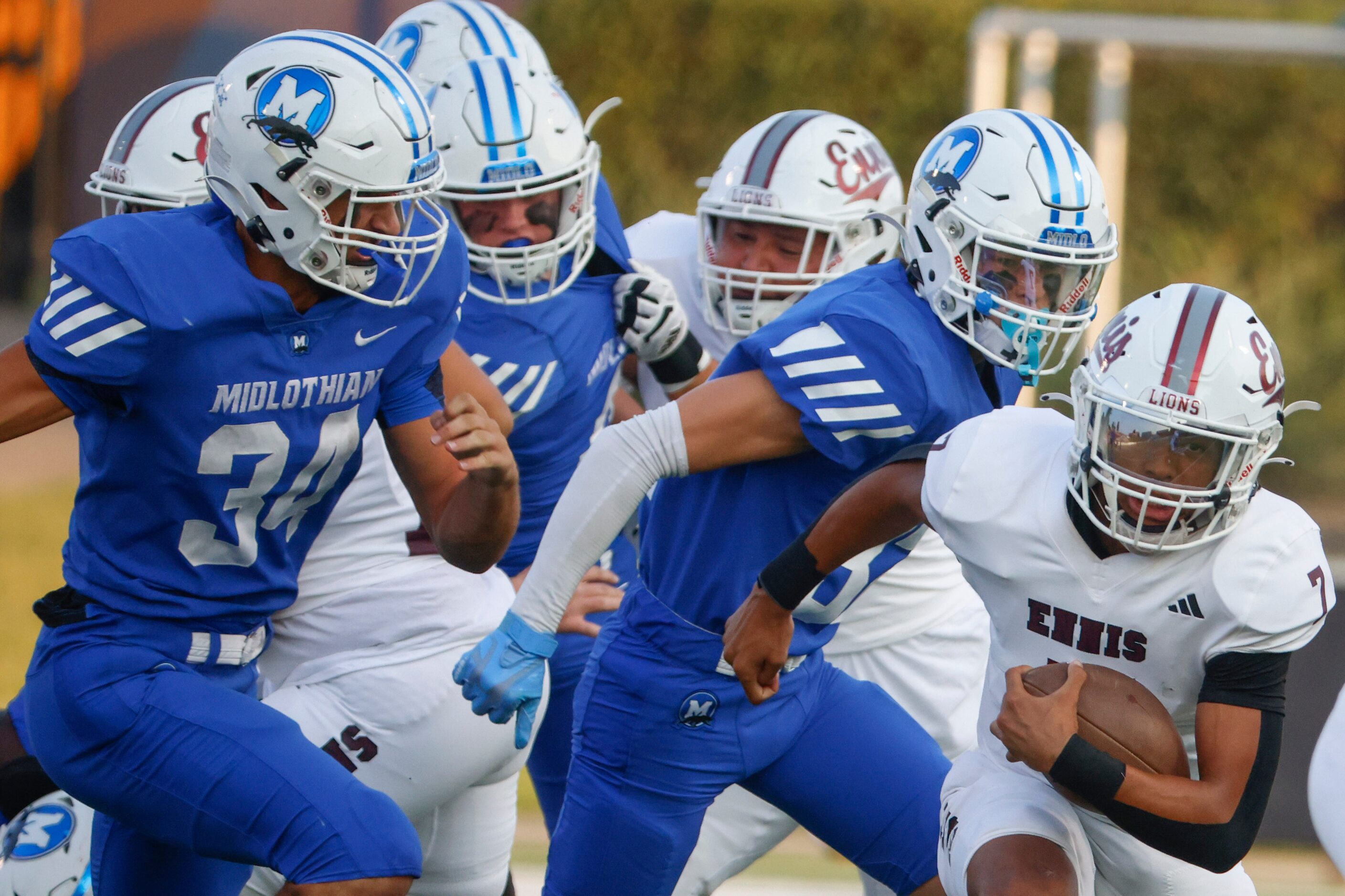 Midlothian high’s players including Jack Ashley (34) runs after Ennis’ QB Wondame Davis Jr....