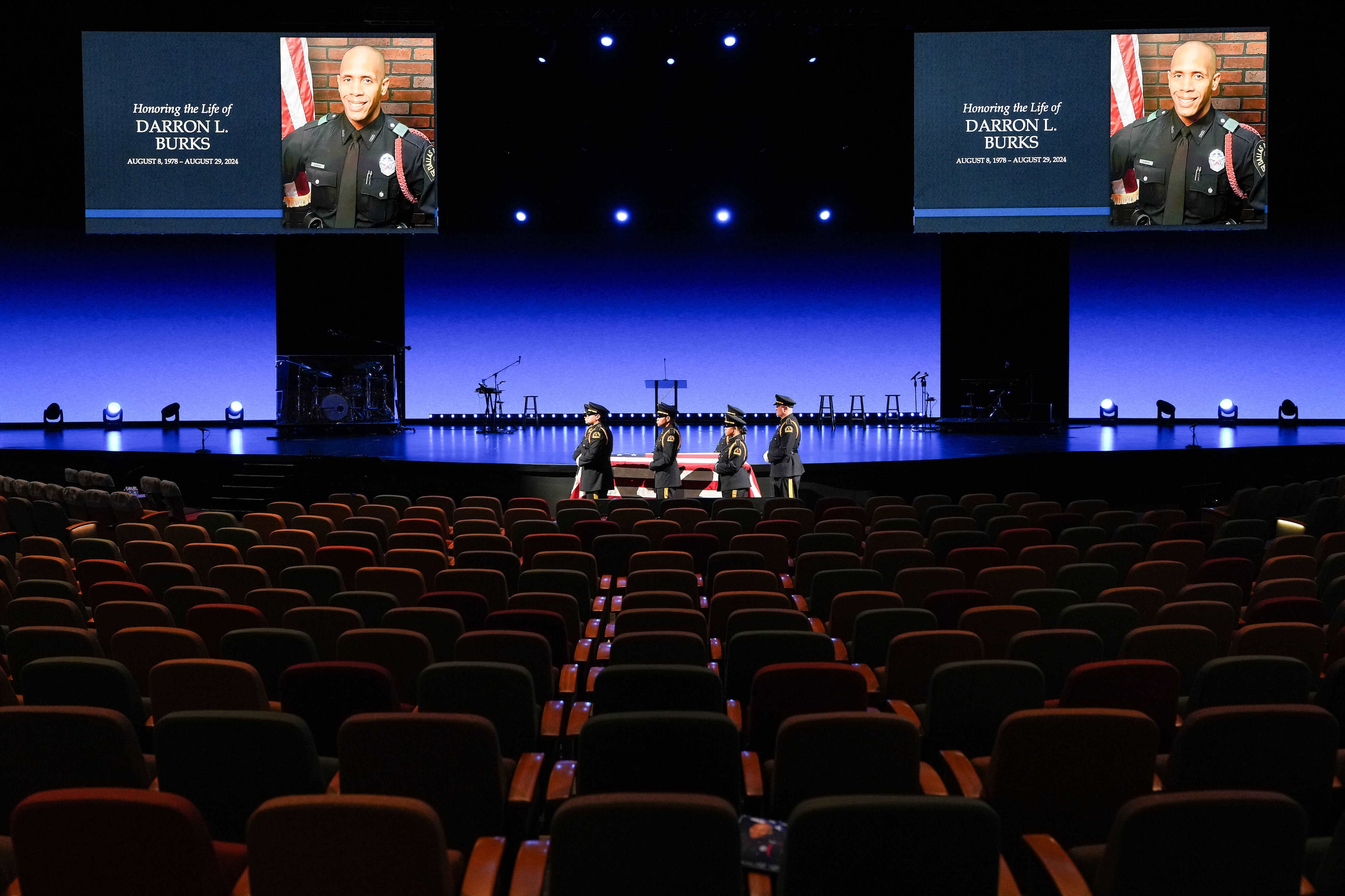 Members of the Dallas Police Honor Guard  stand at the casket of officer Darron Burks as the...