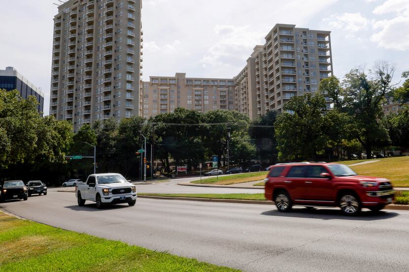 Cars move along Turtle Creek Boulevard and The Renaissance on Turtle Creek, a complex with...