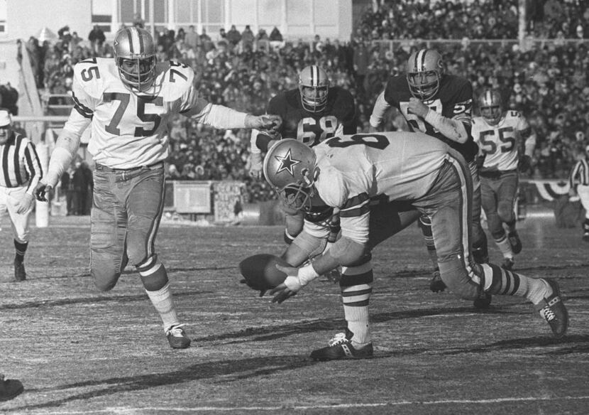 Dallas Cowboys defensive end George Andrie picks up a fumble and is about to follow teammate...