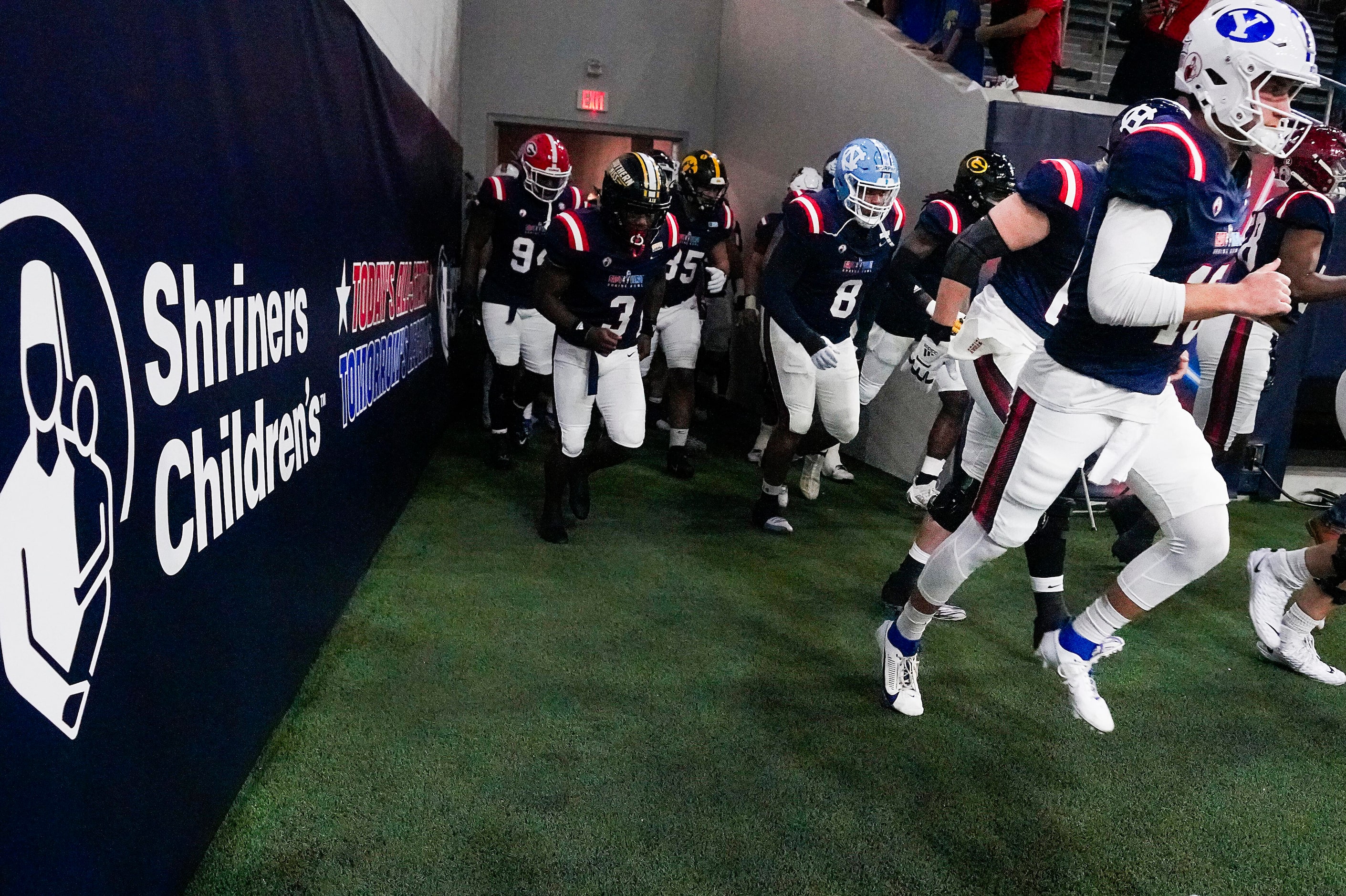 West quarterback Kedon Slovis of BYU (10) take the field before the East-West Shrine Bowl...