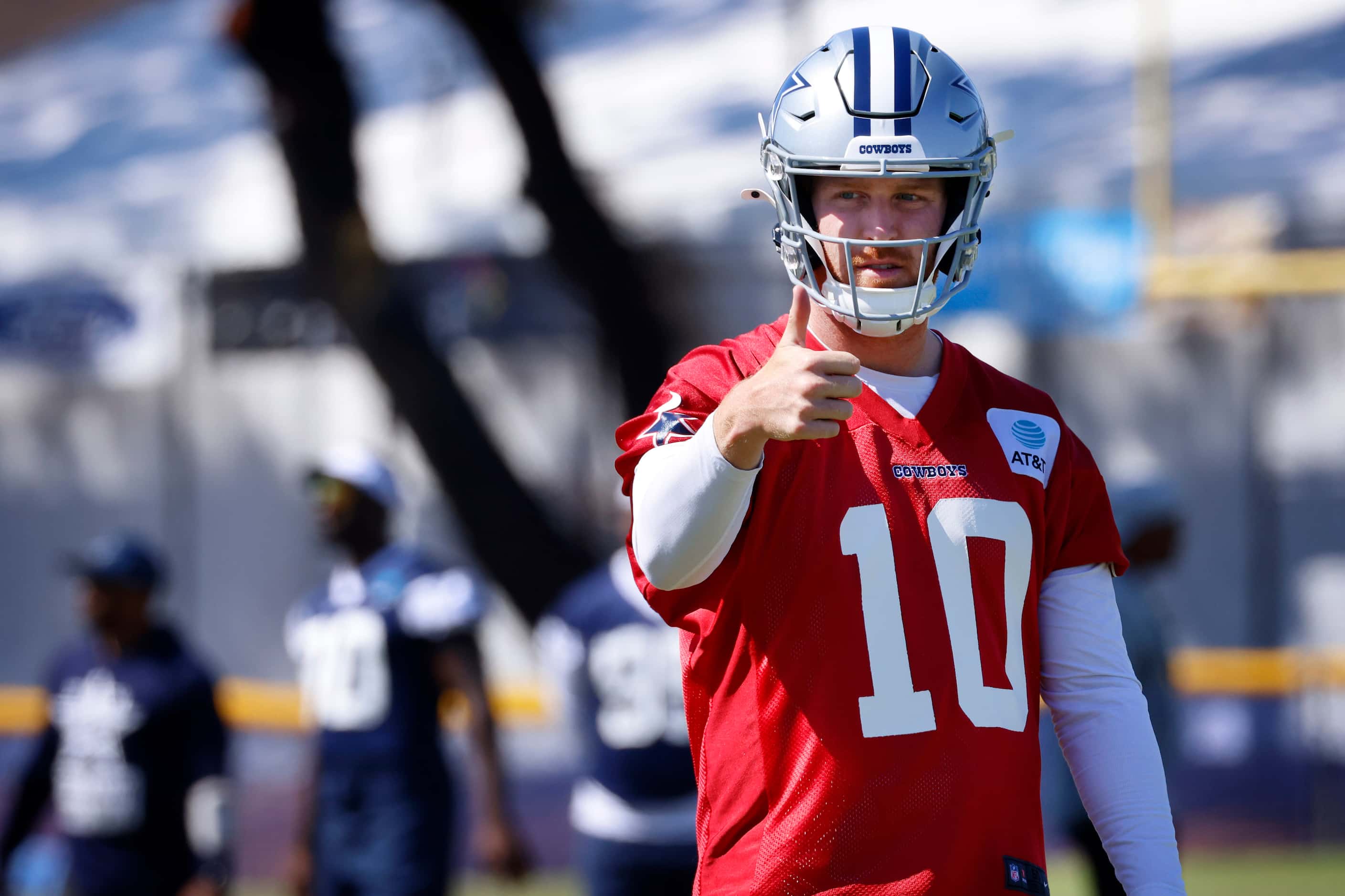 Dallas Cowboys quarterback Cooper Rush (10) gives a thumbs up to his receiver after...